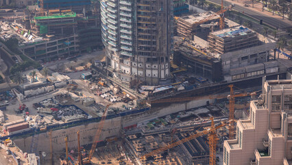 Wall Mural - Under construction high-rise building with yellow construction crane in Dubai timelapse