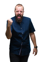 Canvas Print - Young caucasian hipster man over isolated background angry and mad raising fist frustrated and furious while shouting with anger. Rage and aggressive concept.