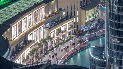 Wall Mural - Lots of tourists walking near fountains and shopping mall in Dubai downtown night timelapse