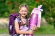 blondes glückliches sechsjähriges Mädchen mit Schultüte und Schulrucksack, erstklässlerin, sonniger tag, schulanfang