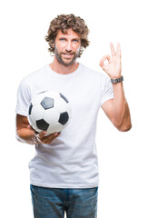 Poster - Handsome hispanic man model holding soccer football ball over isolated background doing ok sign with fingers, excellent symbol