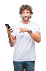 Sticker - Handsome hispanic man model sending message texting using smartphone over isolated background very happy pointing with hand and finger