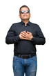 © Krakenimages.com - Middle age arab man wearing sunglasses over isolated background smiling with hands on chest with closed eyes and grateful gesture on face. Health concept.