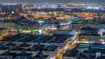 Wall Mural - Aerial view of neighborhood Deira with typical buildings night timelapse, Dubai, United Arab Emirates