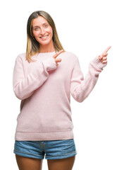 Poster - Young beautiful woman wearing winter sweater over isolated background smiling and looking at the camera pointing with two hands and fingers to the side.