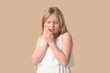 © Pixel-Shot - Young girl suffering from toothache on beige background