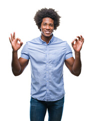 Canvas Print - Afro american man over isolated background relax and smiling with eyes closed doing meditation gesture with fingers. Yoga concept.