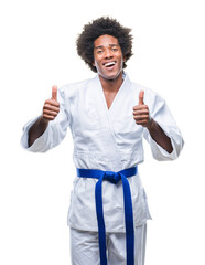 Sticker - Afro american man wearing karate kimono over isolated background success sign doing positive gesture with hand, thumbs up smiling and happy. Looking at the camera with cheerful expression