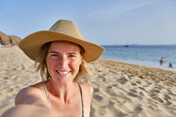 Middle aged woman enjoying summer vacation at the beach