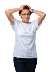 Poster - Beautiful young african american woman wearing glasses over isolated background Crazy and scared with hands on head, afraid and surprised of shock with open mouth