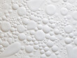 Horizontal bubble texture adds depth to the finishing of a white cement wall