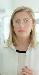 Canvas Print - Serious woman, glasses and optical store for choice, decision and looking at vision or eyesight in mirror. Customer, client or person on trying on new frames, specs and unhappy with shape or quality