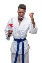 Canvas Print - Young african american man over isolated background wearing kimono holding degree annoyed and frustrated shouting with anger, crazy and yelling with raised hand, anger concept