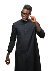 Poster - Young african american priest man over isolated background smiling and confident gesturing with hand doing size sign with fingers while looking and the camera. Measure concept.