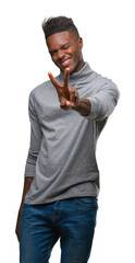 Wall Mural - Young african american man over isolated background smiling looking to the camera showing fingers doing victory sign. Number two.