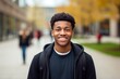 African American student face portrait. Smiling high school guy look at camera. College student face