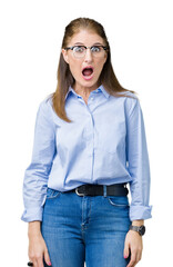 Canvas Print - Beautiful middle age mature business woman wearing glasses over isolated background In shock face, looking skeptical and sarcastic, surprised with open mouth