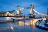 Fototapeta Uliczki - Illuminated Tower Bridge during blue hour, London, the United Kingdom
