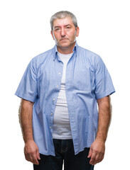 Canvas Print - Handsome senior man over isolated background with serious expression on face. Simple and natural looking at the camera.