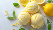 Scoops of lemon gelato with fresh lemon zest and mint leaves on a white background. Refreshing dessert concept. Culinary styling for menu, food blog, poster.