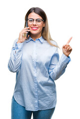 Sticker - Young beautiful business woman speaking calling using smartphone over isolated background very happy pointing with hand and finger to the side