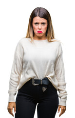 Wall Mural - Young beautiful woman casual white sweater over isolated background depressed and worry for distress, crying angry and afraid. Sad expression.