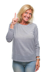 Sticker - Middle age blonde woman over isolated background pointing finger up with successful idea. Exited and happy. Number one.