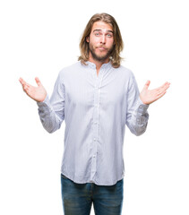 Sticker - Young handsome man with long hair over isolated background clueless and confused expression with arms and hands raised. Doubt concept.