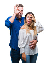 Poster - Young couple in love over isolated background doing ok gesture shocked with surprised face, eye looking through fingers. Unbelieving expression.