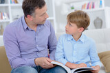 Fototapeta  - dad and his son reading a book