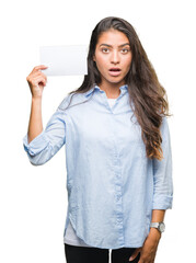 Poster - Young arab woman holding blank card over isolated background scared in shock with a surprise face, afraid and excited with fear expression