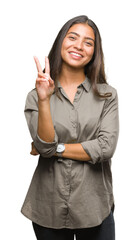 Wall Mural - Young beautiful arab woman over isolated background smiling with happy face winking at the camera doing victory sign. Number two.