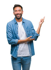 Sticker - Adult hispanic man over isolated background with a big smile on face, pointing with hand and finger to the side looking at the camera.