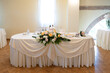 wedding sweetheart table arranged with floral centerpiece and elegant tableware