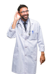 Poster - Adult hispanic doctor man over isolated background smiling with hand over ear listening an hearing to rumor or gossip. Deafness concept.