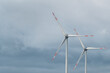 Two synchronous wind turbines under the cloudy sky