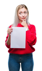 Poster - Young blonde woman holding blank paper sheet over isolated background serious face thinking about question, very confused idea