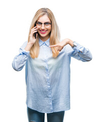 Wall Mural - Young beautiful blonde business woman calling on smartphone over isolated background with surprise face pointing finger to himself