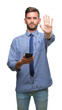 © Krakenimages.com - Young hadsome man texting sending message using smartphone over isolated background with open hand doing stop sign with serious and confident expression, defense gesture