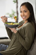 smiling happy woman eating a salad