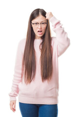 Canvas Print - Young Chinese woman over isolated background wearing glasses angry and mad raising fist frustrated and furious while shouting with anger. Rage and aggressive concept.