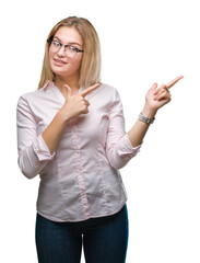 Poster - Young caucasian business woman wearing glasses over isolated background smiling and looking at the camera pointing with two hands and fingers to the side.