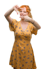 Sticker - Young redhead woman smiling making frame with hands and fingers with happy face. Creativity and photography concept.