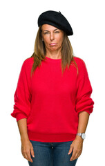 Wall Mural - middle age adult woman wearing fashion beret over isolated background skeptic and nervous, frowning 