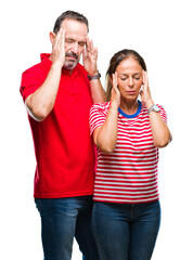 Wall Mural - Middle age hispanic couple in love over isolated background with hand on head for pain in head because stress. Suffering migraine.