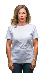 Wall Mural - middle age senior hispanic woman over isolated background with serious expression on face. simple an