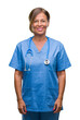 © Krakenimages.com - Middle age senior nurse doctor woman over isolated background with a happy and cool smile on face. Lucky person.