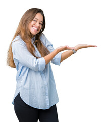 Canvas Print - Young beautiful brunette business woman over isolated background Pointing to the side with hand and open palm, presenting ad smiling happy and confident