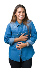 Canvas Print - Young beautiful brunette woman wearing blue denim shirt over isolated background Smiling and laughing hard out loud because funny crazy joke. Happy expression.