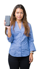 Sticker - Young beautiful brunette business woman showing screen of smartphone over isolated background with a confident expression on smart face thinking serious